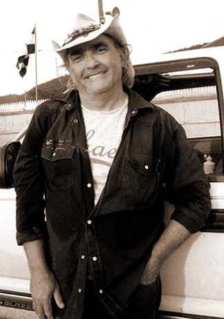 "img src="cowboy310.png" alt="cowboy songwriter leaning against an old truck">