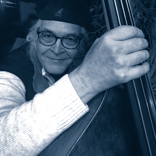 "img src="Jim4.png" alt="smiling bass player grips stand-up base for photo">