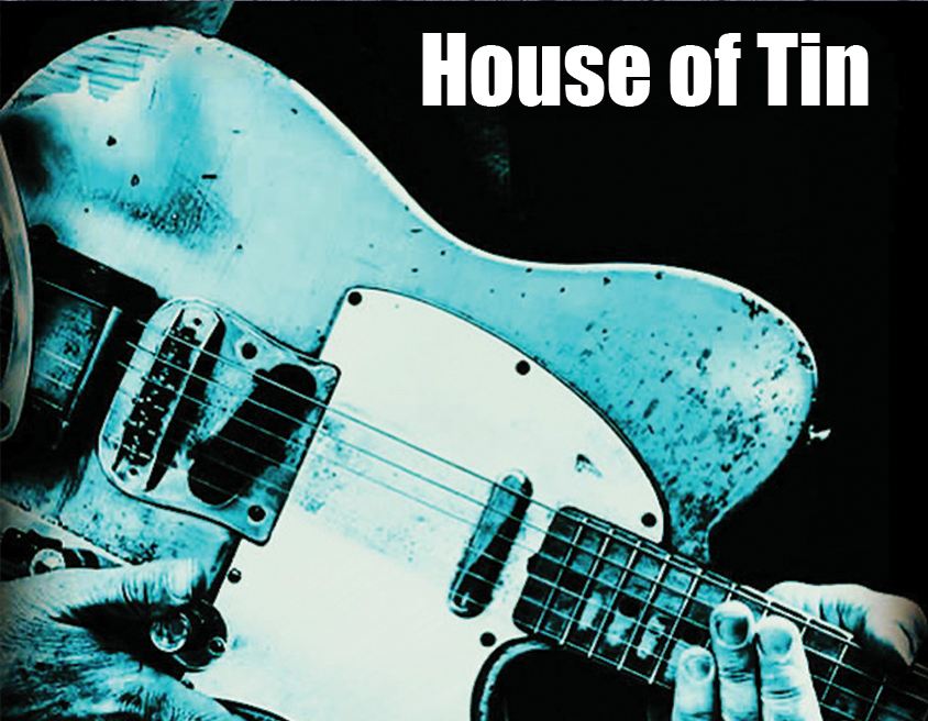 img src="House-of-Tin.png" well worn guitar is in the hands of the player">